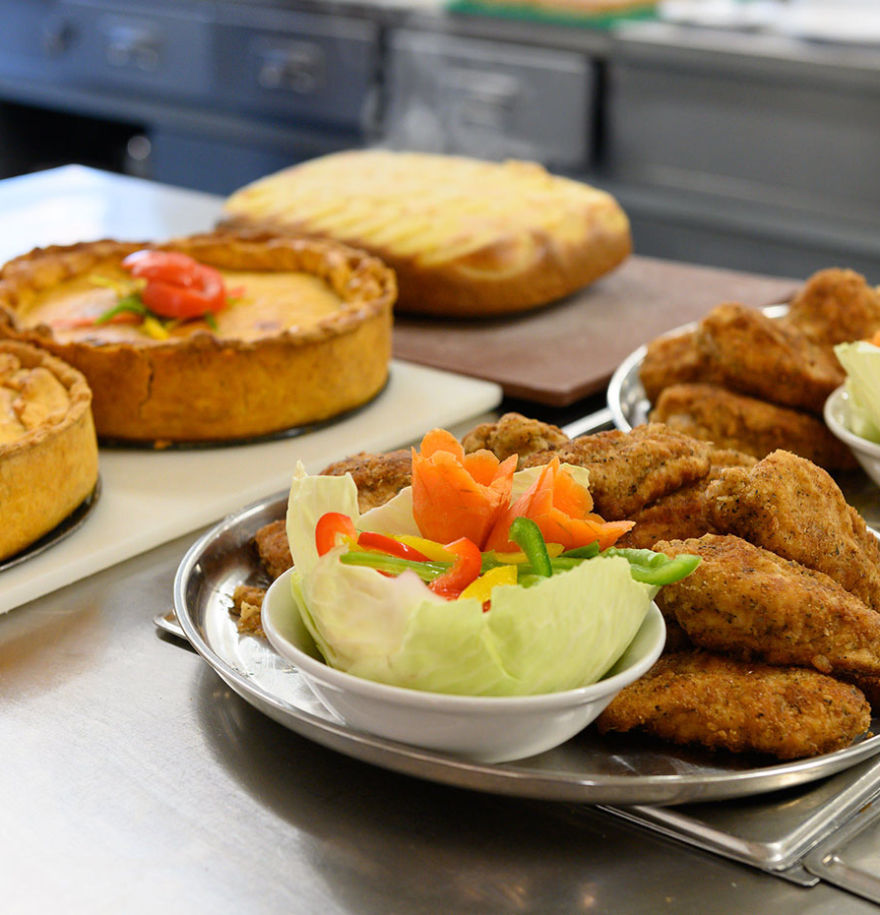 An up close of fried cuisine on the right and pies on the left.